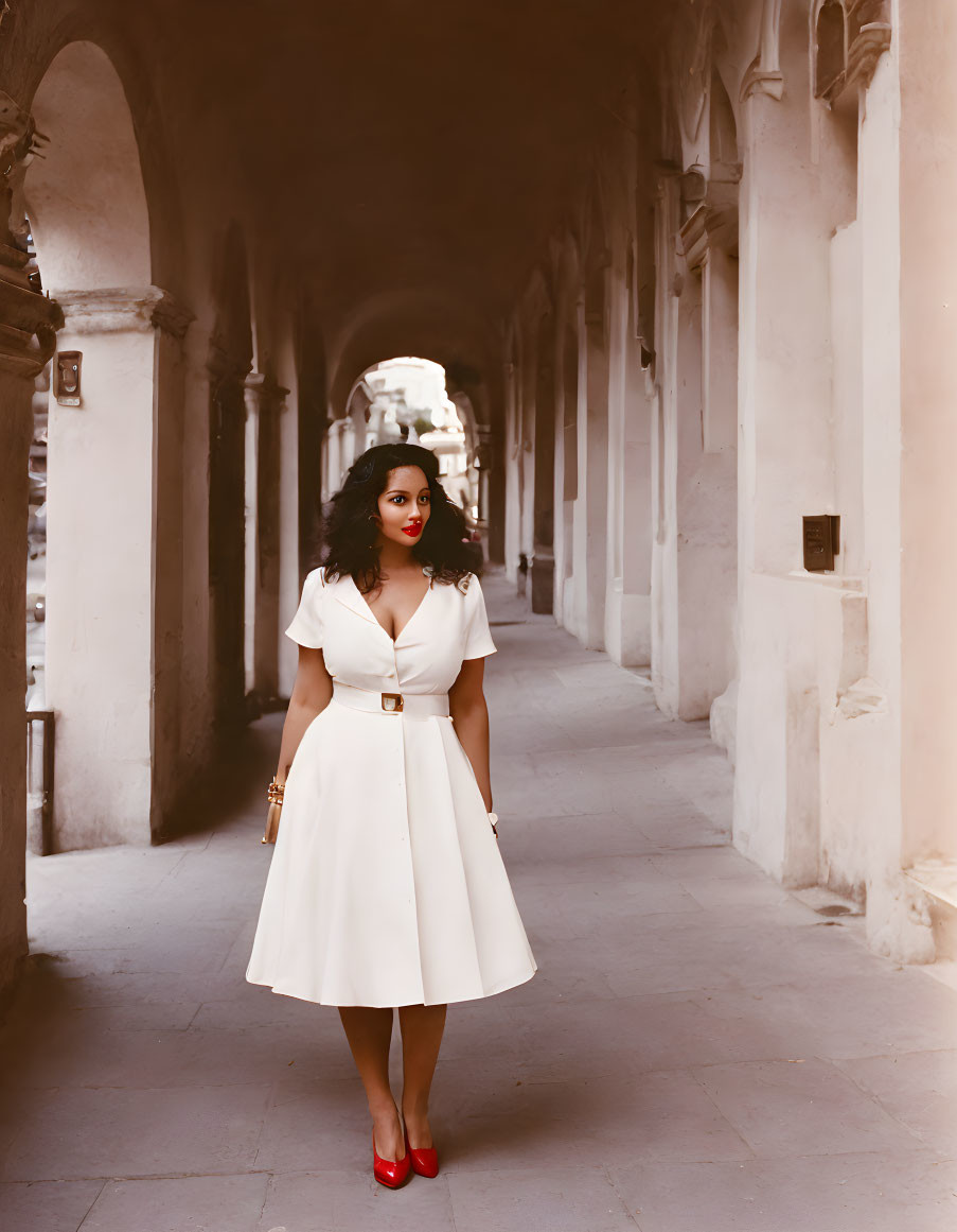 Vintage Style Photography of Woman in White Dress and Red Shoes Under Arcade