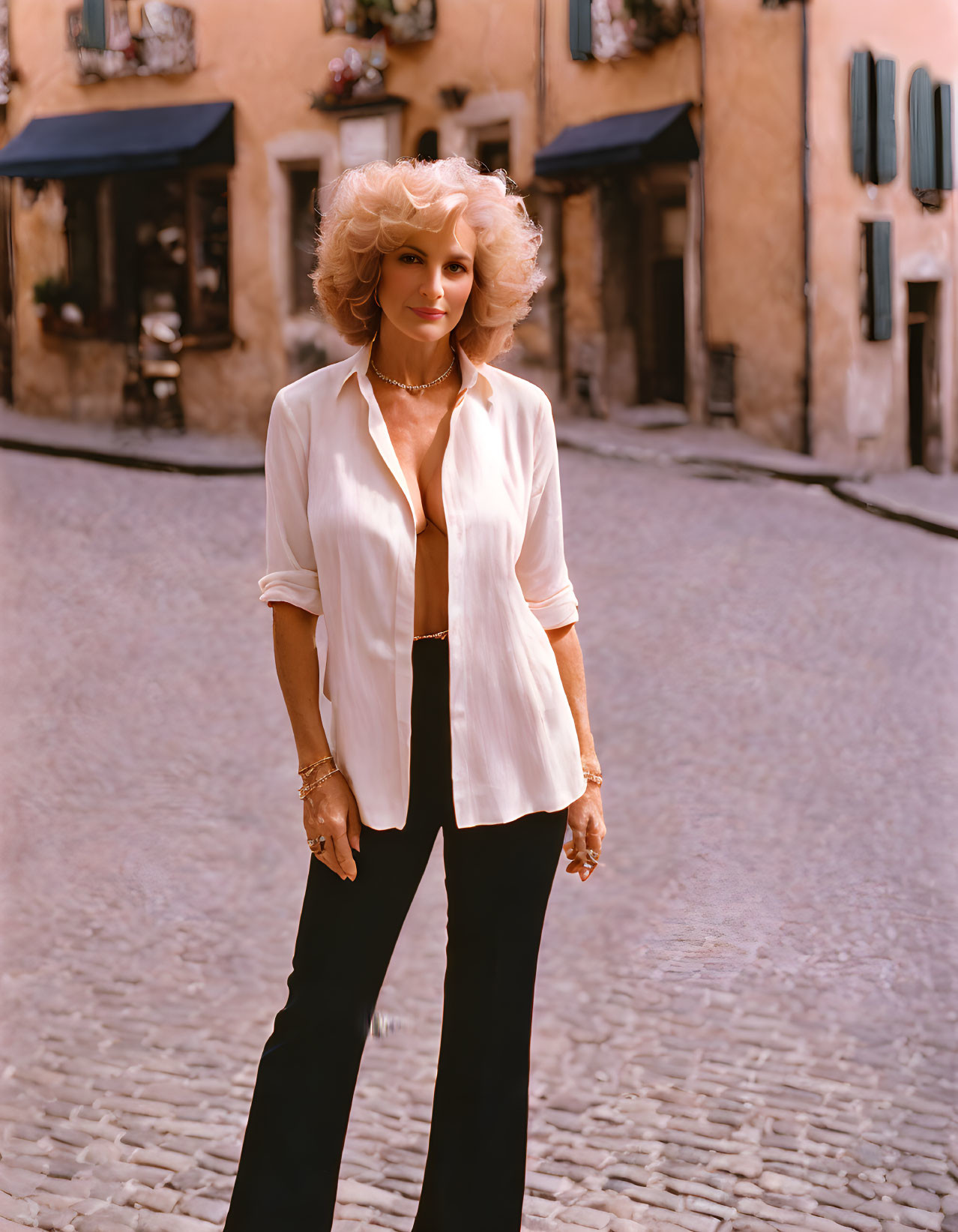 Blonde woman in white blouse on colorful cobblestone street