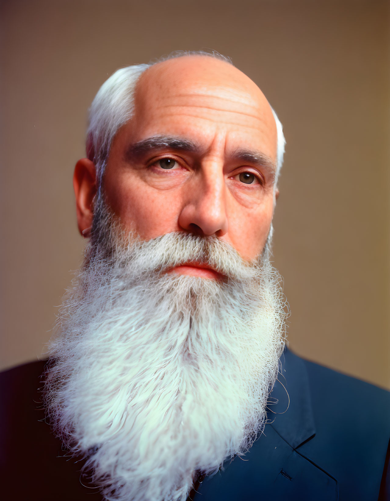 Elderly man with long white beard and blue suit portrait