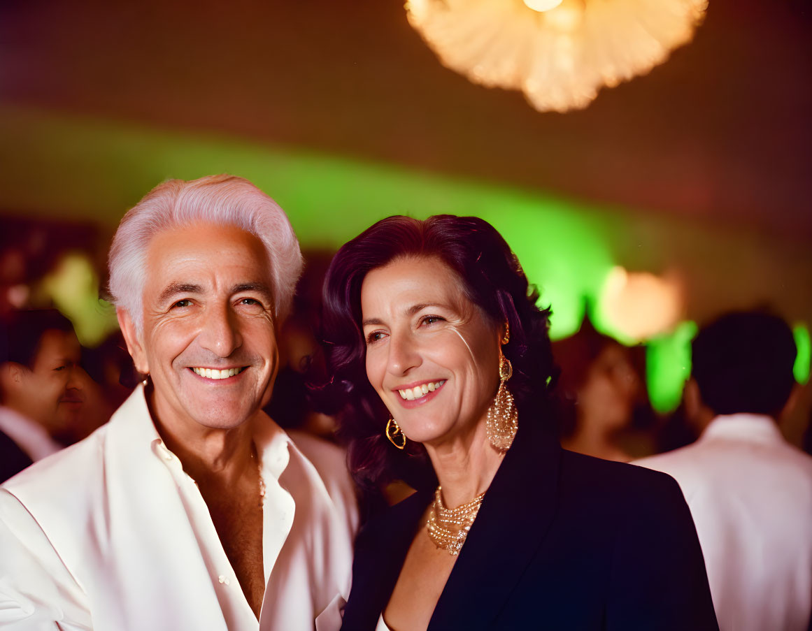 Stylish couple in white jacket & black dress at social event