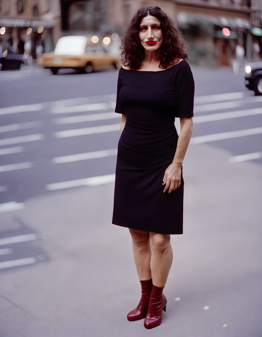 Woman in Black Dress and Red Boots on City Street with Yellow Taxi