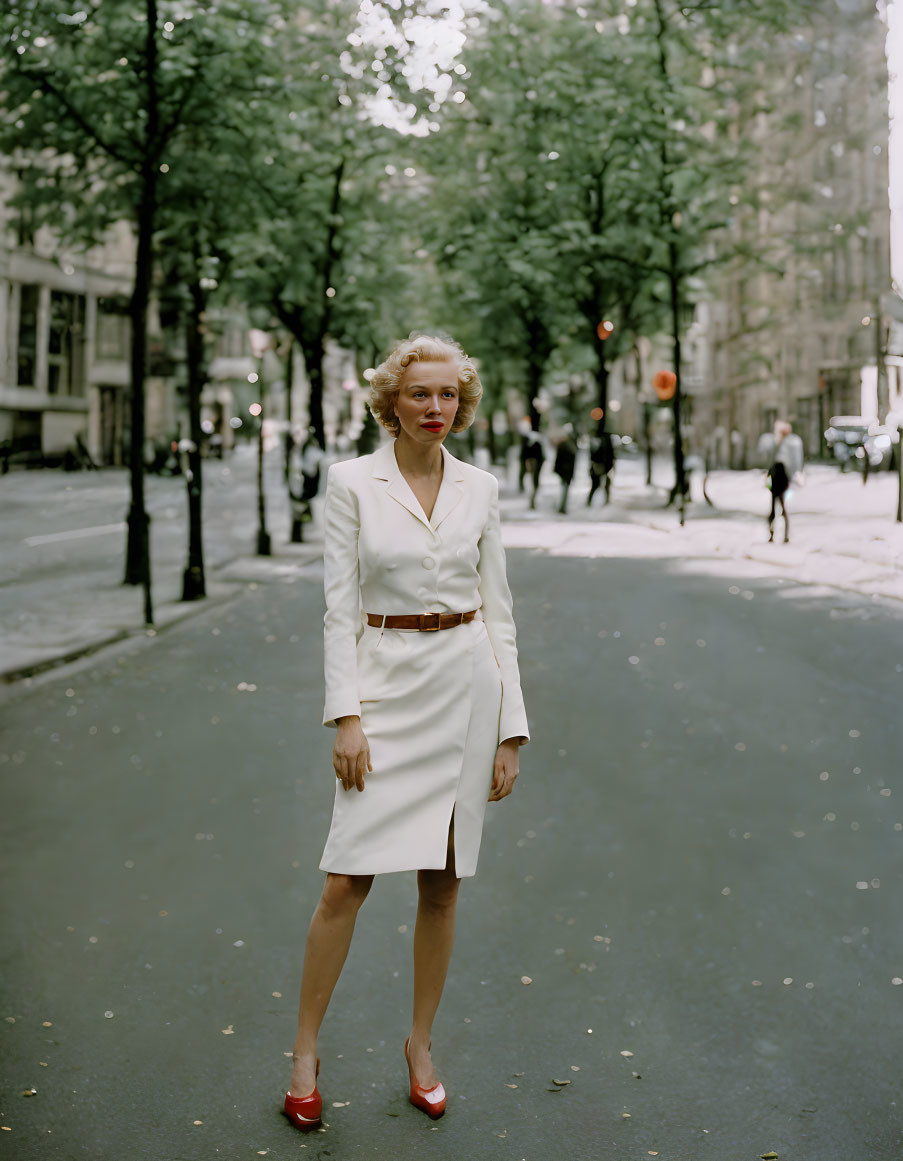 Woman in White Dress on Tree-Lined Street with People Walking