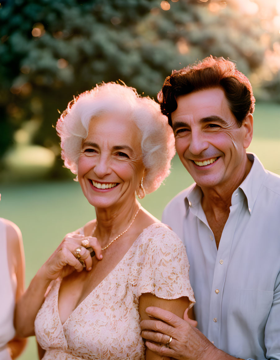 Elderly couple smiling warmly in sunlit garden