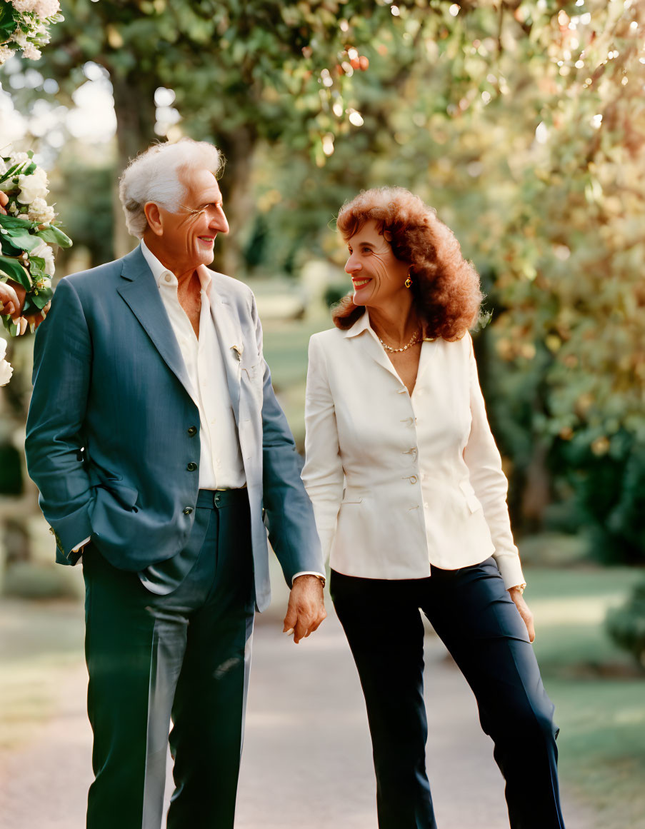 Elderly Couple Smiling Holding Hands Outdoors