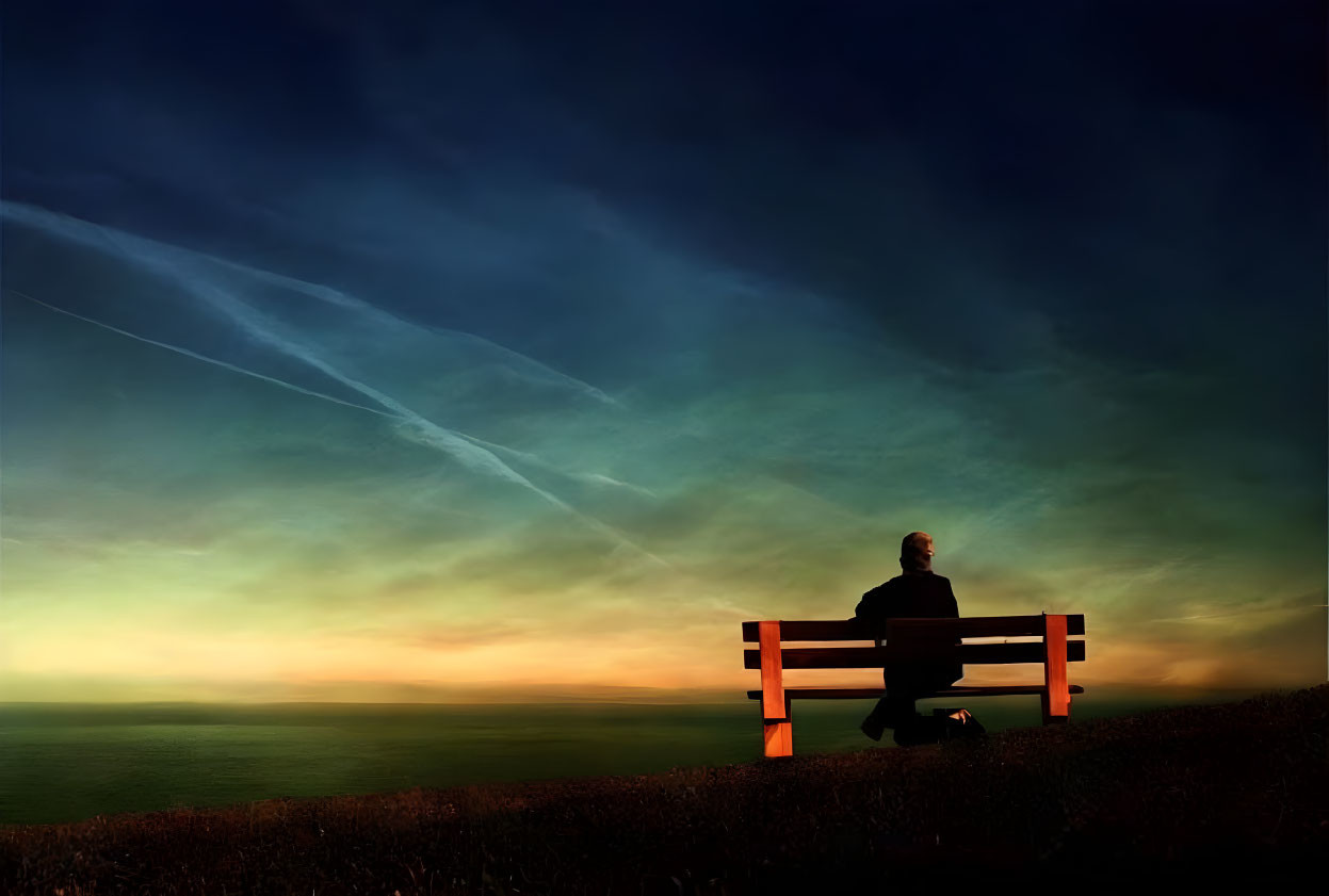 Person sitting on bench under twilight sky by ocean