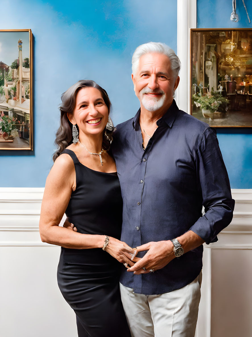 Smiling couple in room with blue walls and artwork