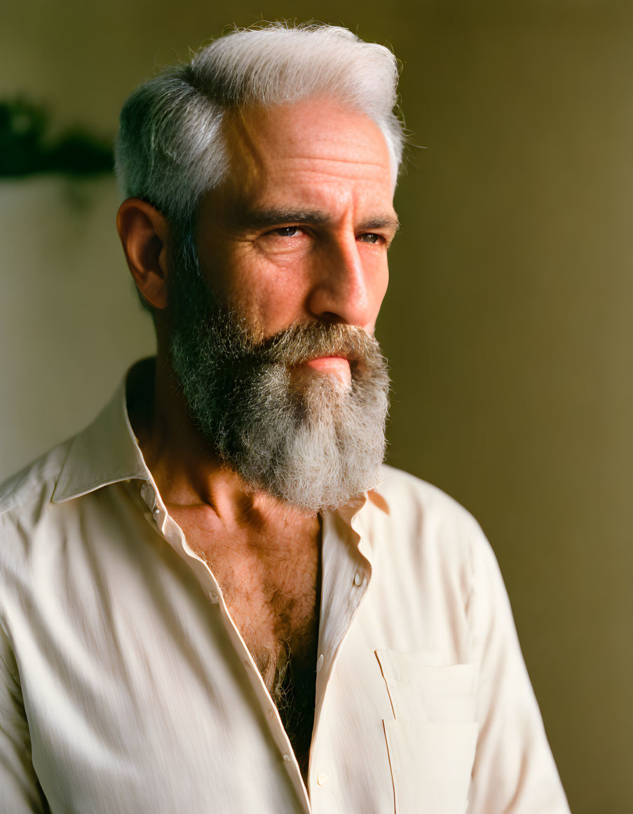 Elderly man with white beard and mustache in light shirt