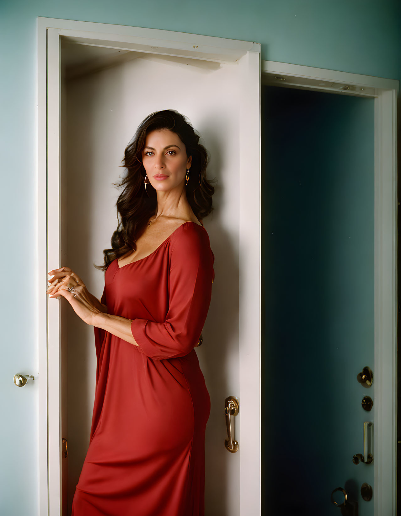 Woman in Red Dress Poses by Open White Door