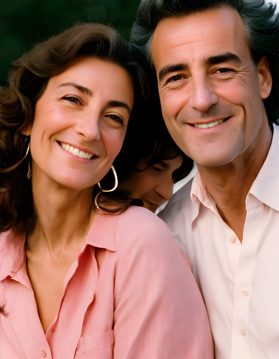 Smiling family portrait with child in background