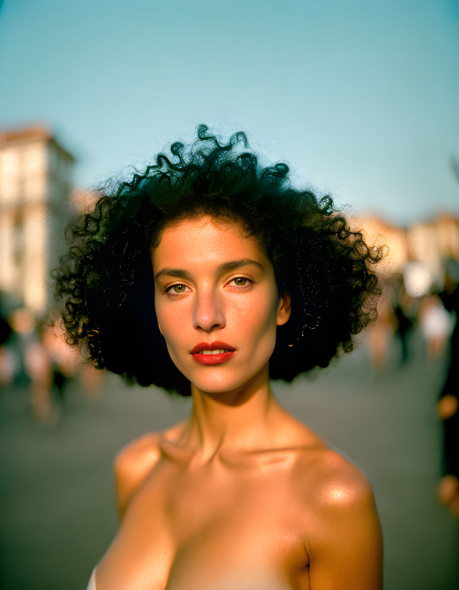 Woman with Voluminous Curly Hair in Busy Street Portrait