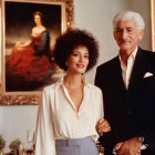 Sophisticatedly dressed couple in room with classic painting.