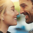 Close-Up Portrait of Smiling Man and Woman in Warm Sunlight