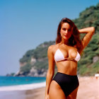 Woman in White and Black Bikini on Sunny Beach with Mountains and Blue Sky