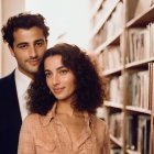 Smiling couple embracing in library setting