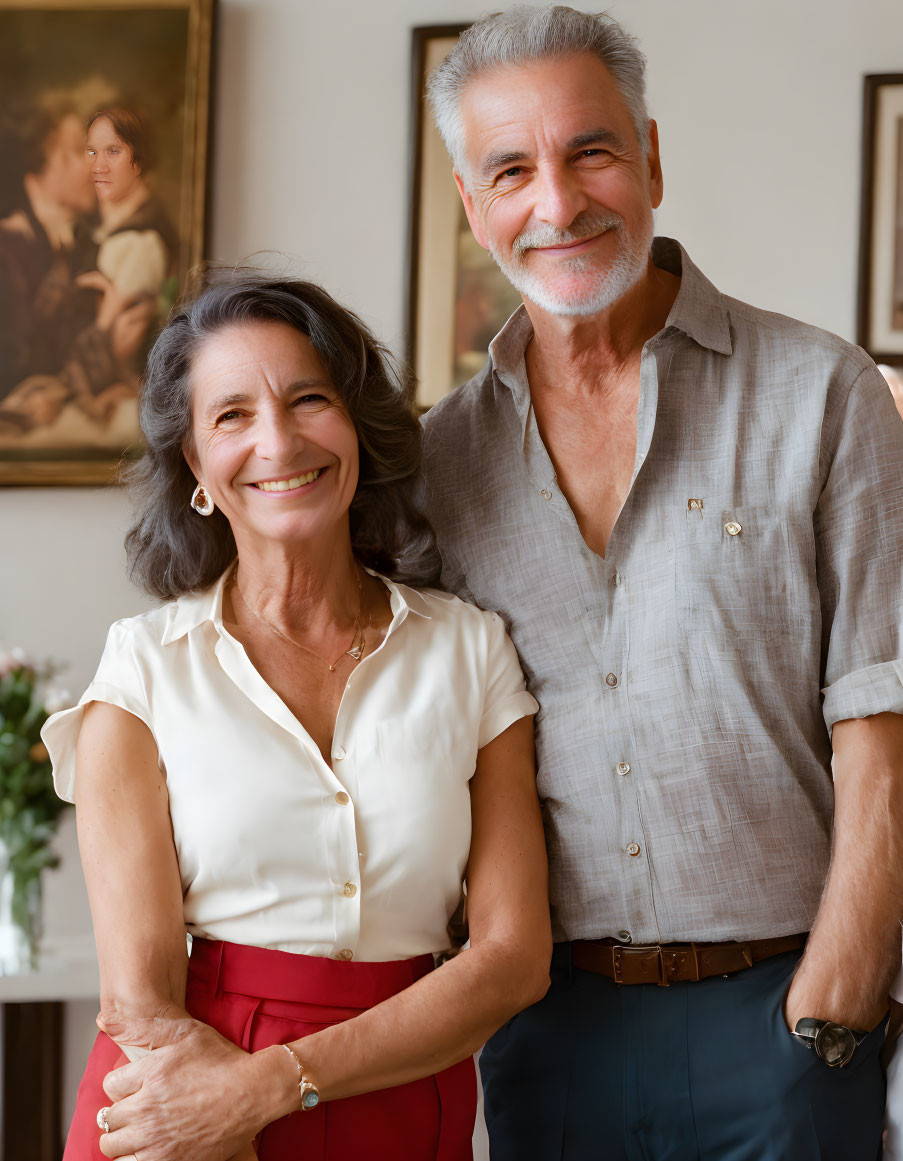 Elderly couple standing with classic painting in background