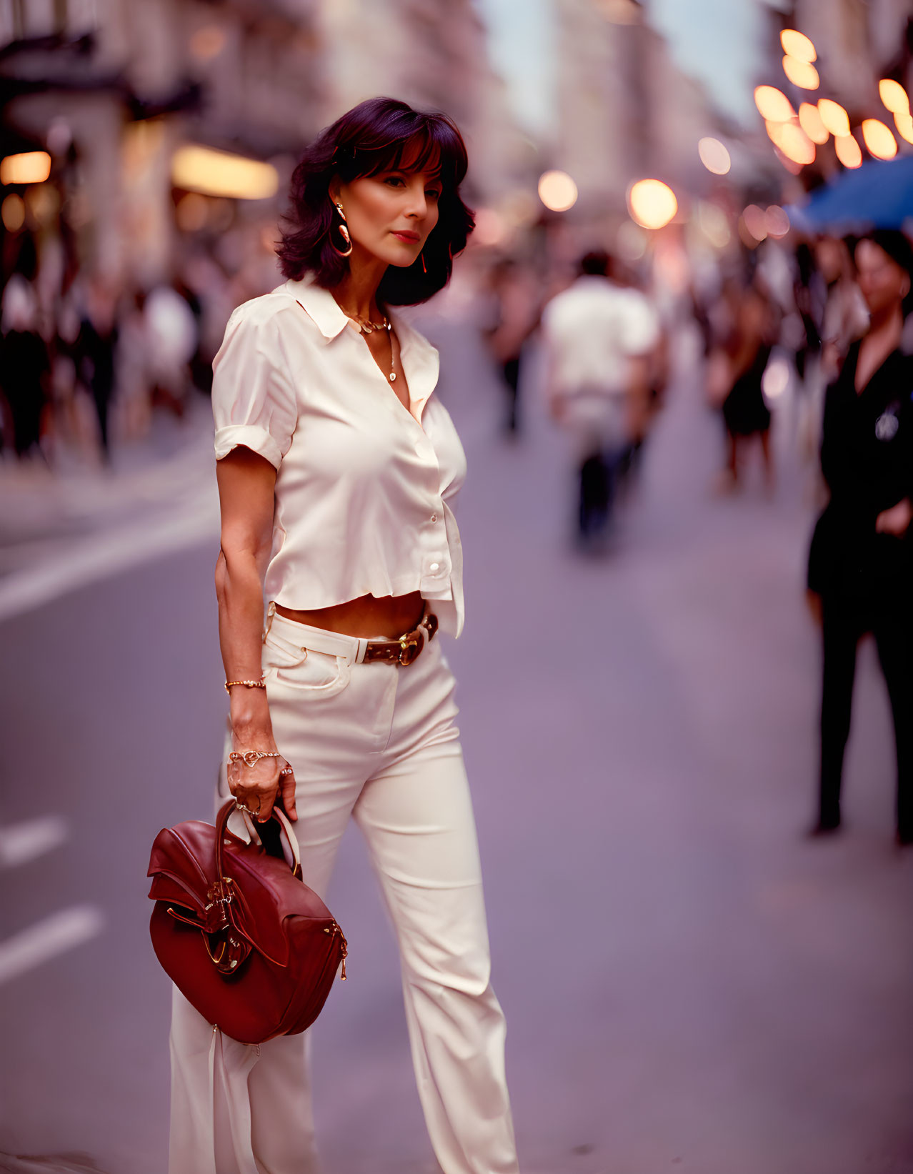 Fashionable Woman in White Shirt and Trousers with Red Handbag on City Street