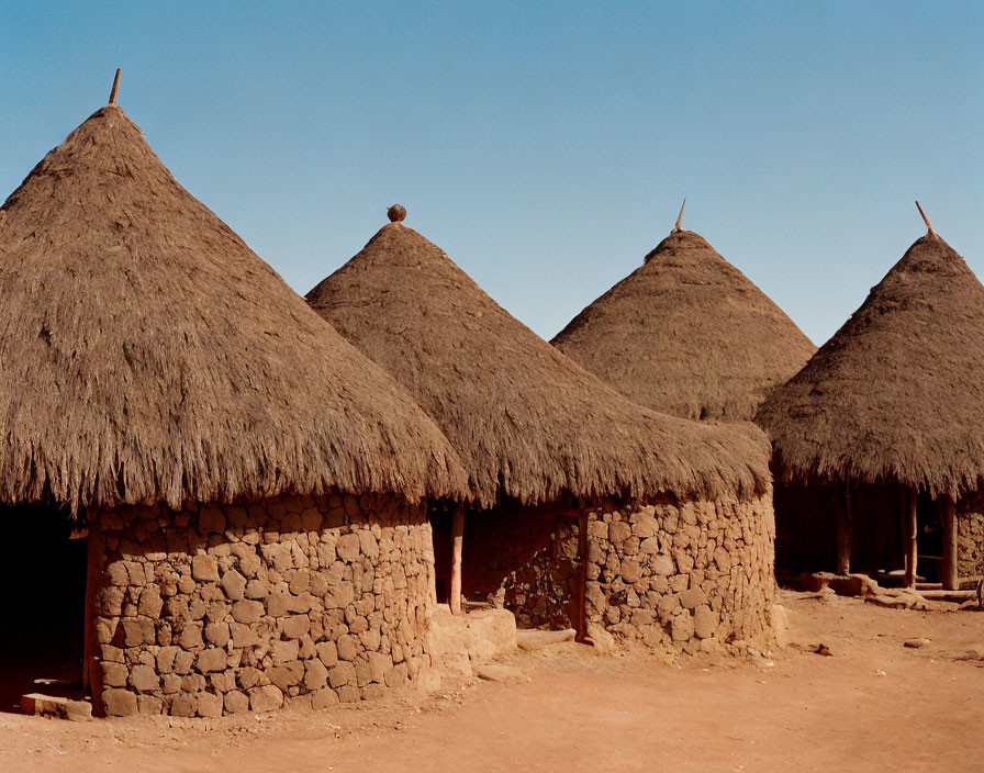 Thatched-Roof Mud Huts in Dry Sandy Area