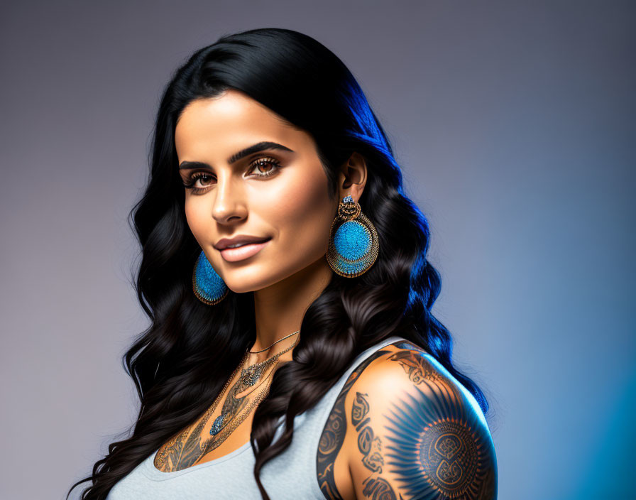 Dark-haired woman with blue earrings and tattoos on shoulder and chest on gradient background.