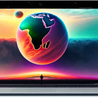 Colorful outer space wallpaper with large Earth on laptop screen