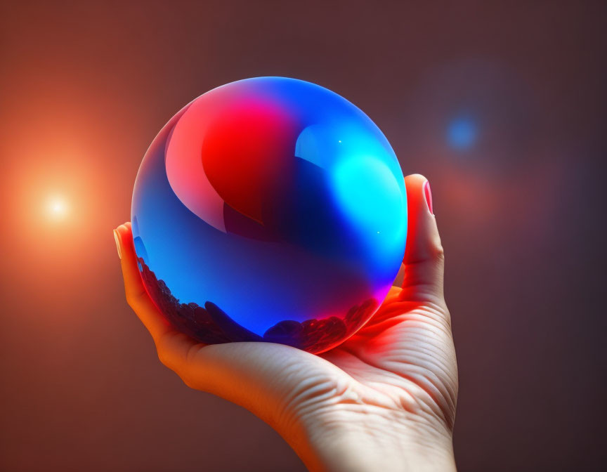 Translucent sphere held by hand against warm backdrop