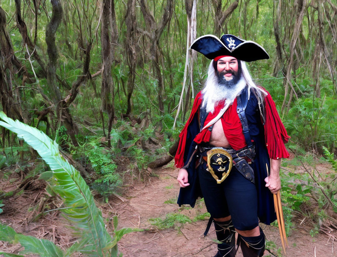 Person in pirate costume with hat, beard, eye patch, sword, red sash, and blue