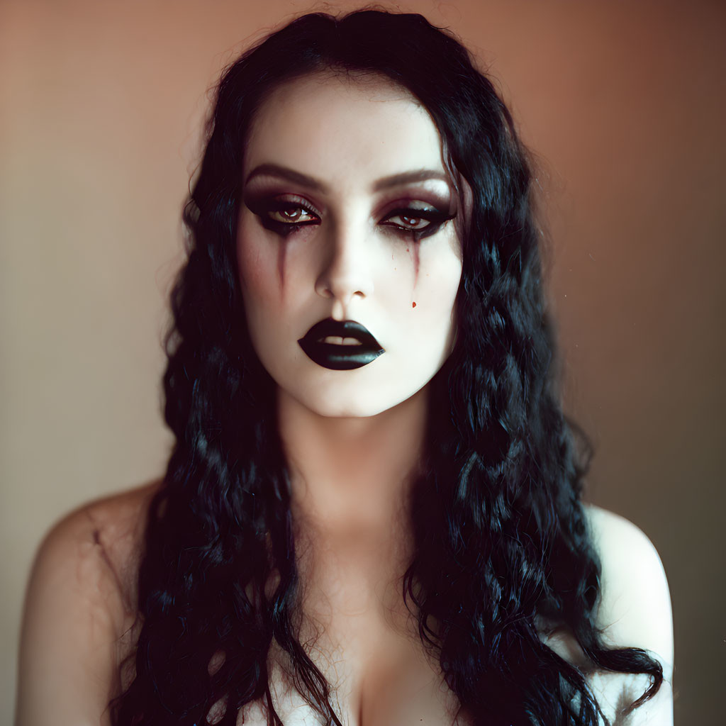 Portrait of a person with dark makeup and black lipstick, wavy hair, and a somber expression