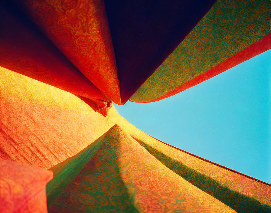 Colorful Textile Canopy Against Blue Sky Forming Abstract Composition