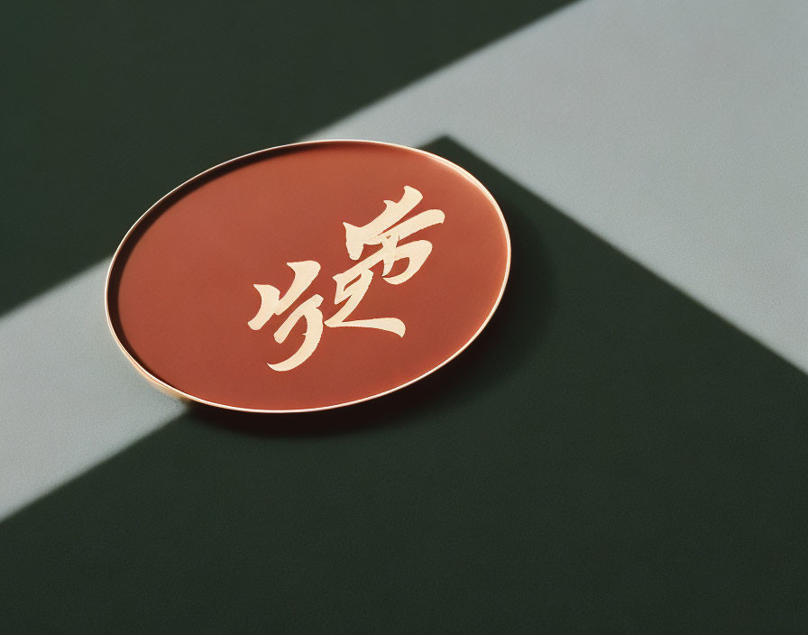 Circular red object with Asian characters on green and black surface.