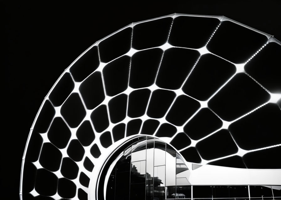 Modern honeycomb design structure in monochrome against dark backdrop.