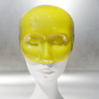 Yellow Reflective Mannequin Head on Blurred Background