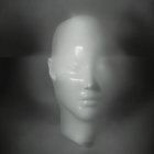 Monochrome serene mannequin head in mist with light reflection