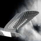 Futuristic building with wing-like structures in misty cityscape