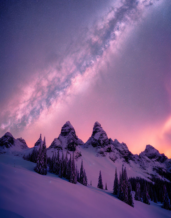 Twilight sky with pink clouds over snow-covered mountain peaks