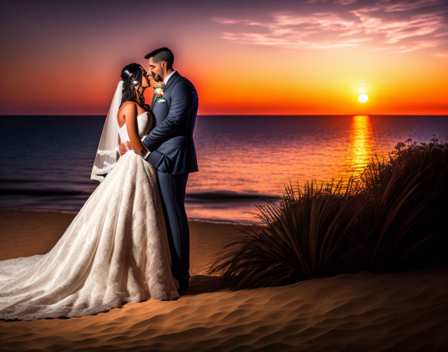 Wedding couple embraces on beach at sunset with vivid orange skies