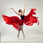 Ballet dancer in pointe shoes with swirling multicolored skirt