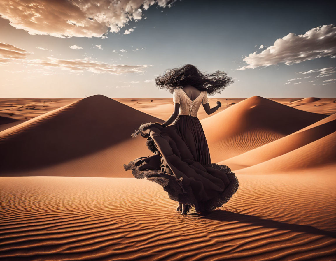 Woman in flowing dress in desert dunes under vast sky