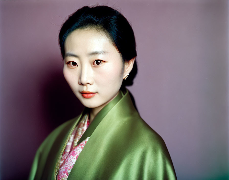 Portrait of Woman in Green Silk Garment on Purple Background