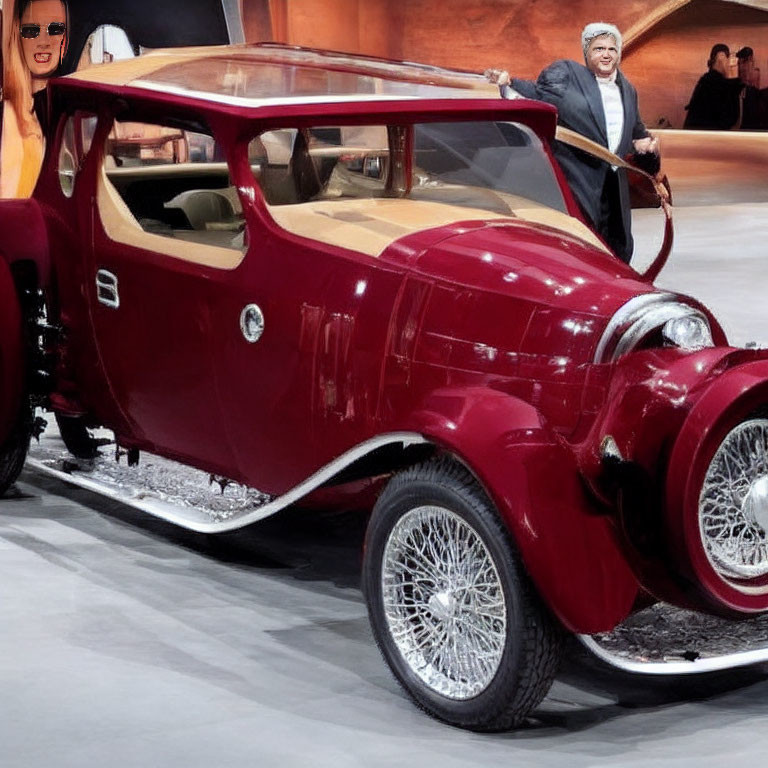 Vintage Red Car Displayed with Person in Suit at Event Background with Graphics