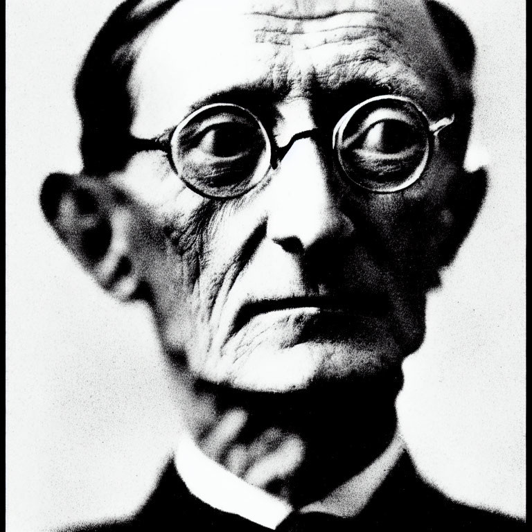 Monochrome portrait of stern elderly man with round glasses