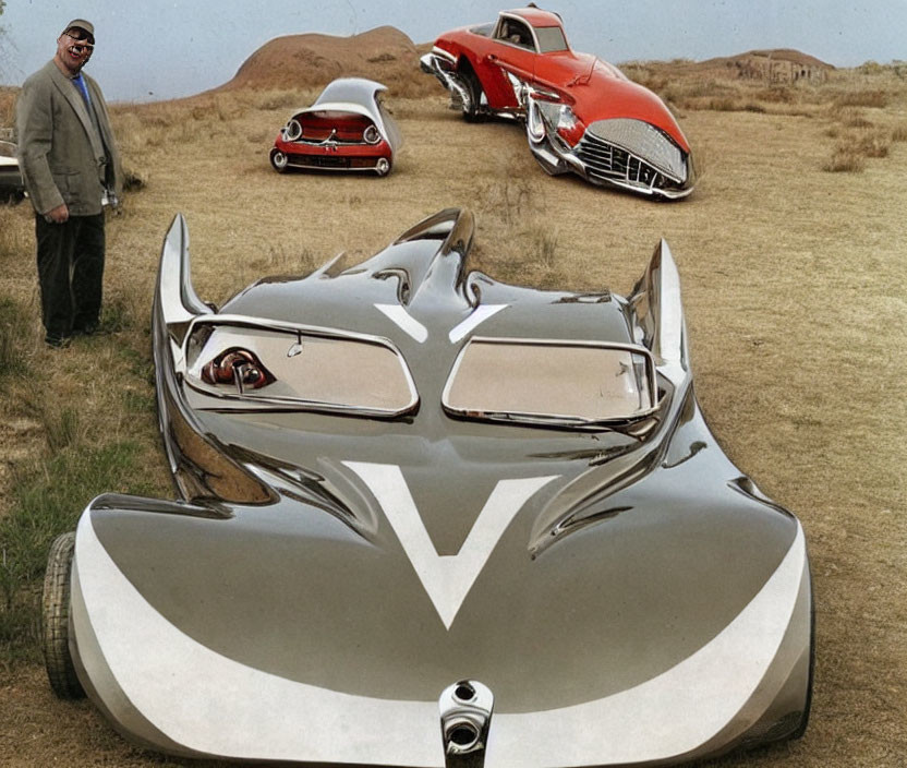 Man smiling by surreal landscape with oversized buried car parts