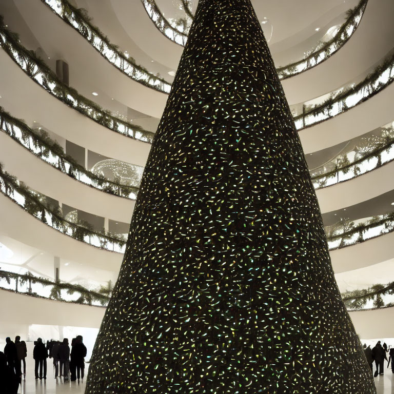 Indoor Christmas tree with twinkling lights and silhouetted figures