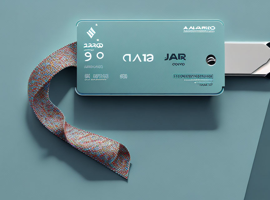 Blue-green credit card partially inserted in wallet on teal background