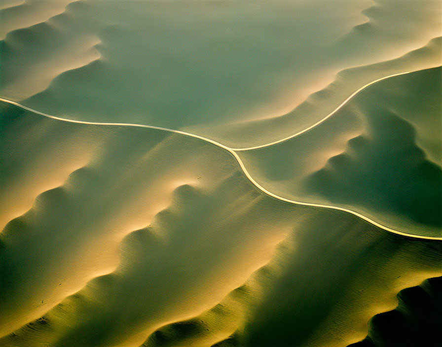 Desert dunes aerial view with shadow patterns and light contrast