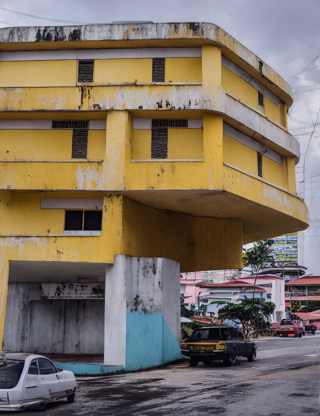 Weathered Yellow Multi-Story Parking Garage on Cloudy Day