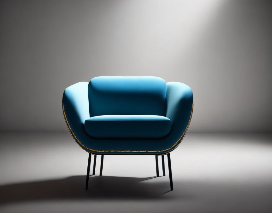 Modern Blue Armchair with Gold Trim on Black Legs in Spotlight