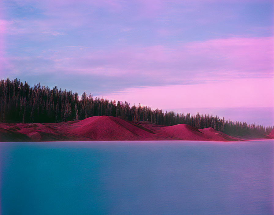 Tranquil lake with vivid blue waters and pink sky over dense forest