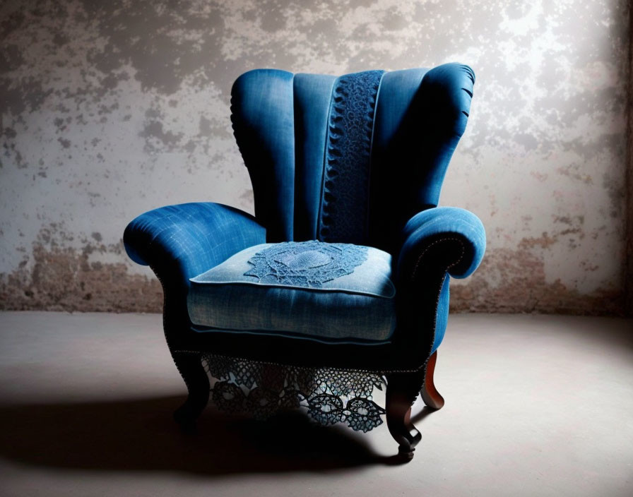 Vintage Blue Upholstered Armchair with Ornate Wooden Legs and Decorative Pillow