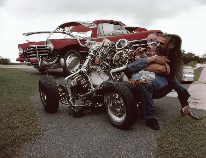 Man crouching with oversized engine next to classic car on roadside