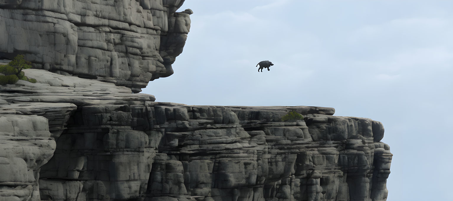 Silhouette of person levitating above rugged cliff in cloudy sky.