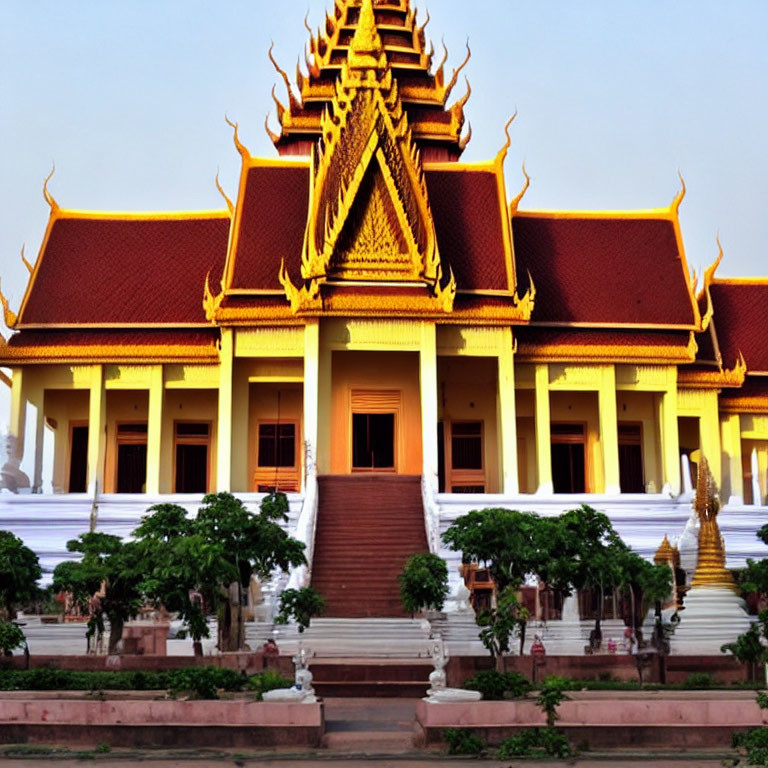 Traditional Golden-Roofed Temple with Red Steps in Southeast Asian Architecture